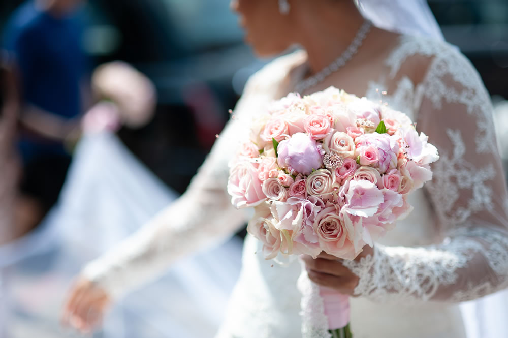 Bride holding bouquet outside church