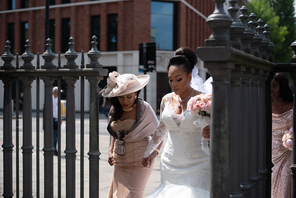 Bride entering church yard with mother