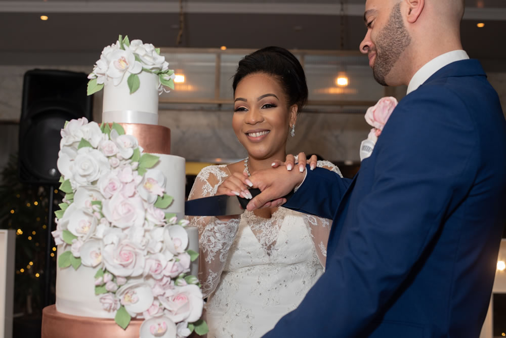Couple cutting wedding cake