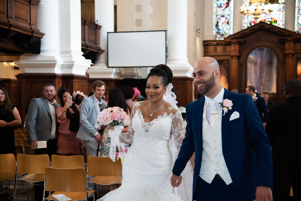Couple walking down the aisle out of the church