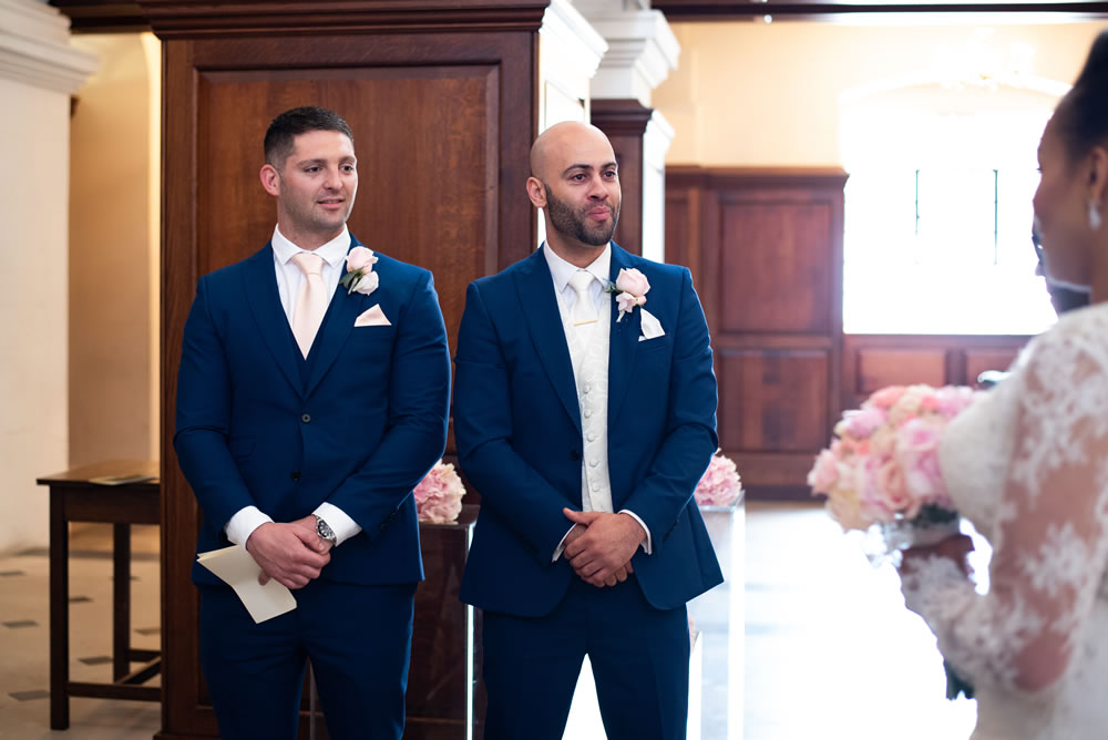 Groom and best man as bride arrives at altar