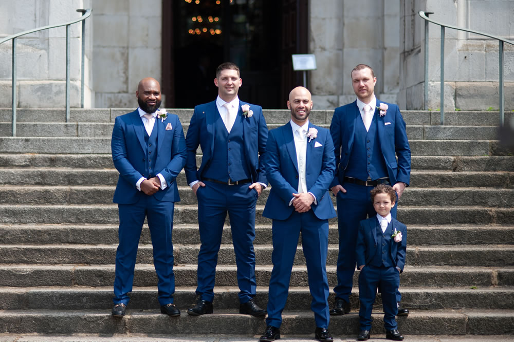 Groom and wedding party on church steps