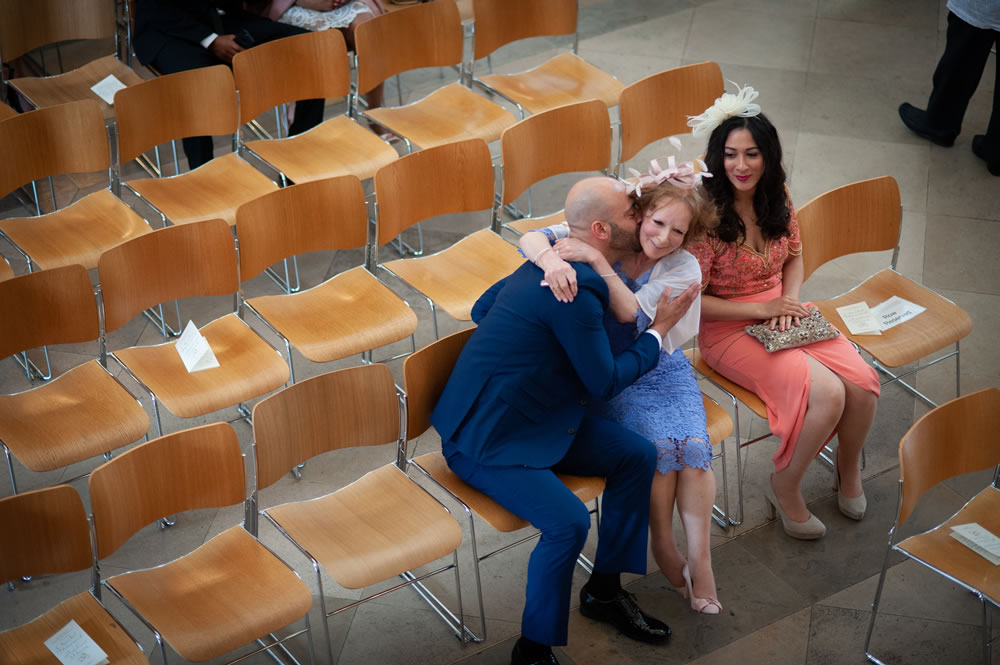 Groom hugging his mother in the church