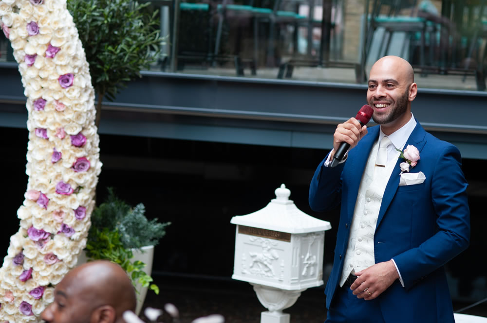 Groom smiling during his speech