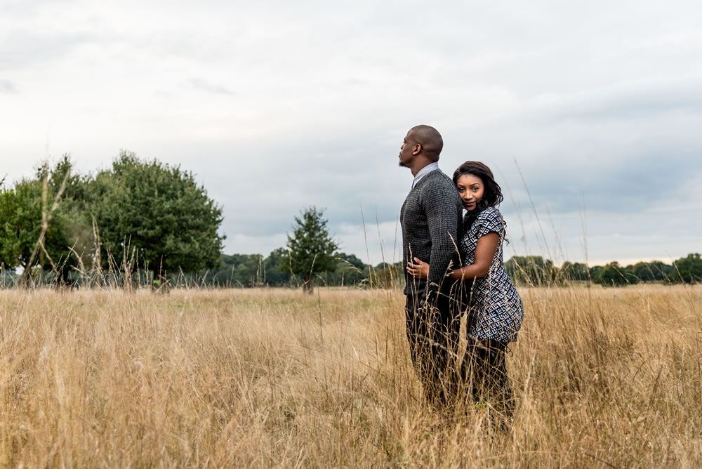 Bride with arms around groom&rsquo;s waist and leaning on his back