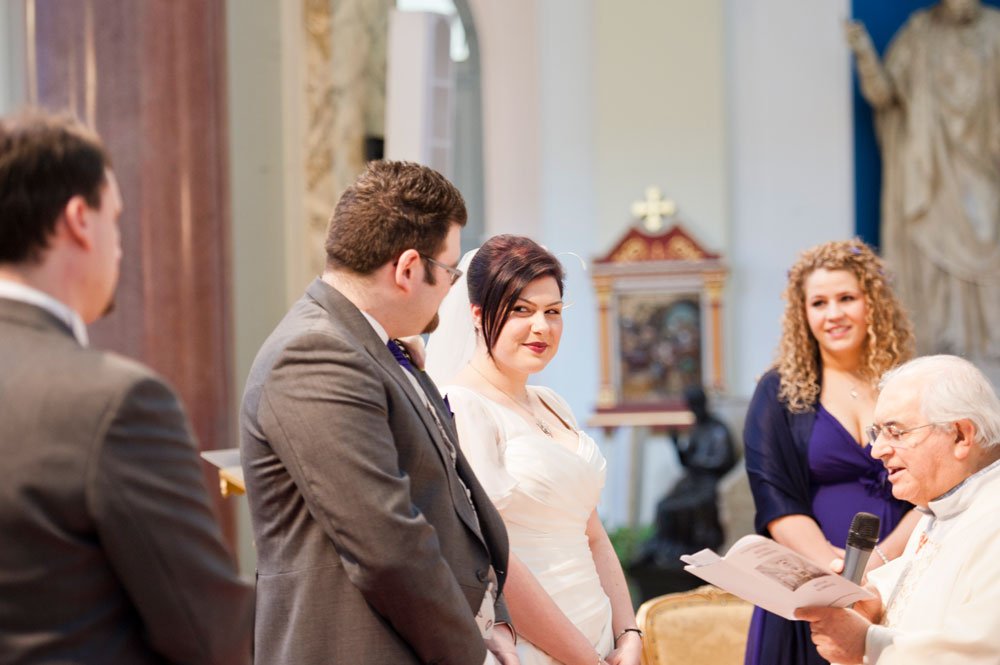 Bride and groom looking at each other at the altar