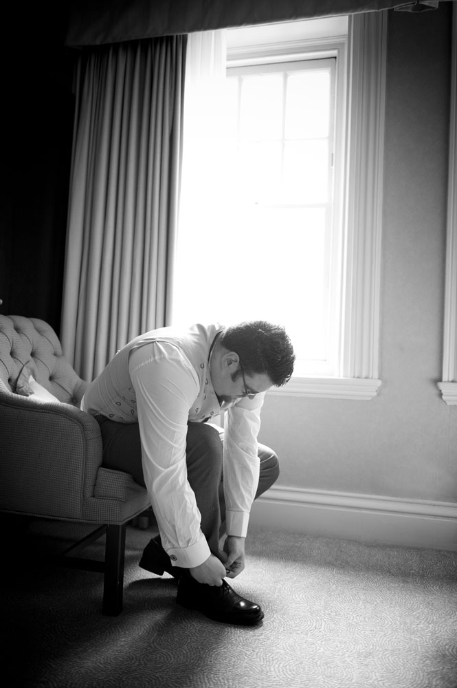 Groom putting on shoes