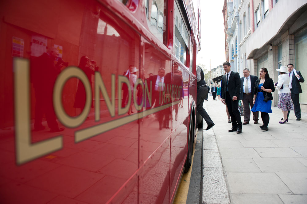 Guests getting on London bus