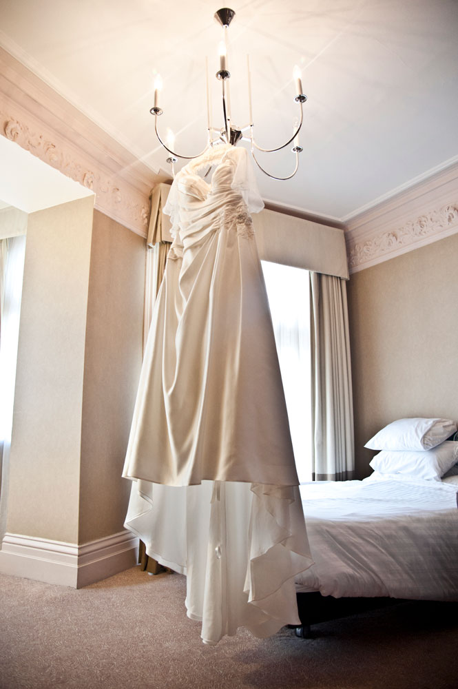 Wedding dress hanging on chandelier