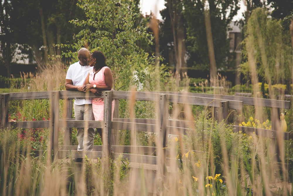Couple kissing on bridge