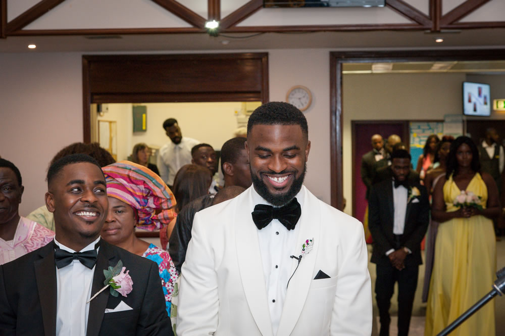 Best man looking at the groom while stood at the altar