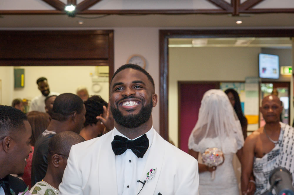 Groom smiling while at altar