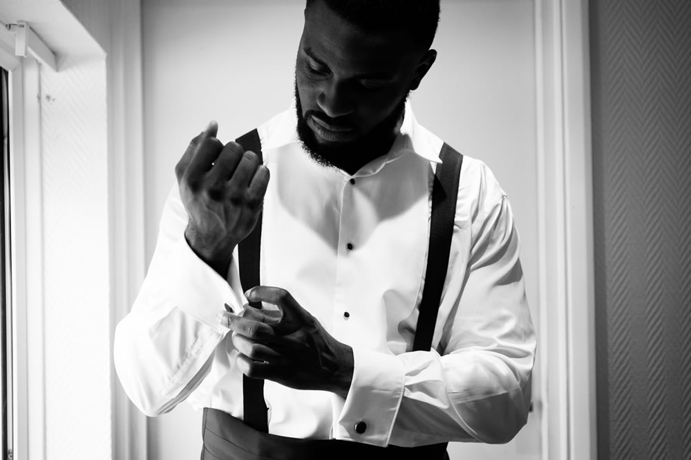 Groom fixing his cufflinks