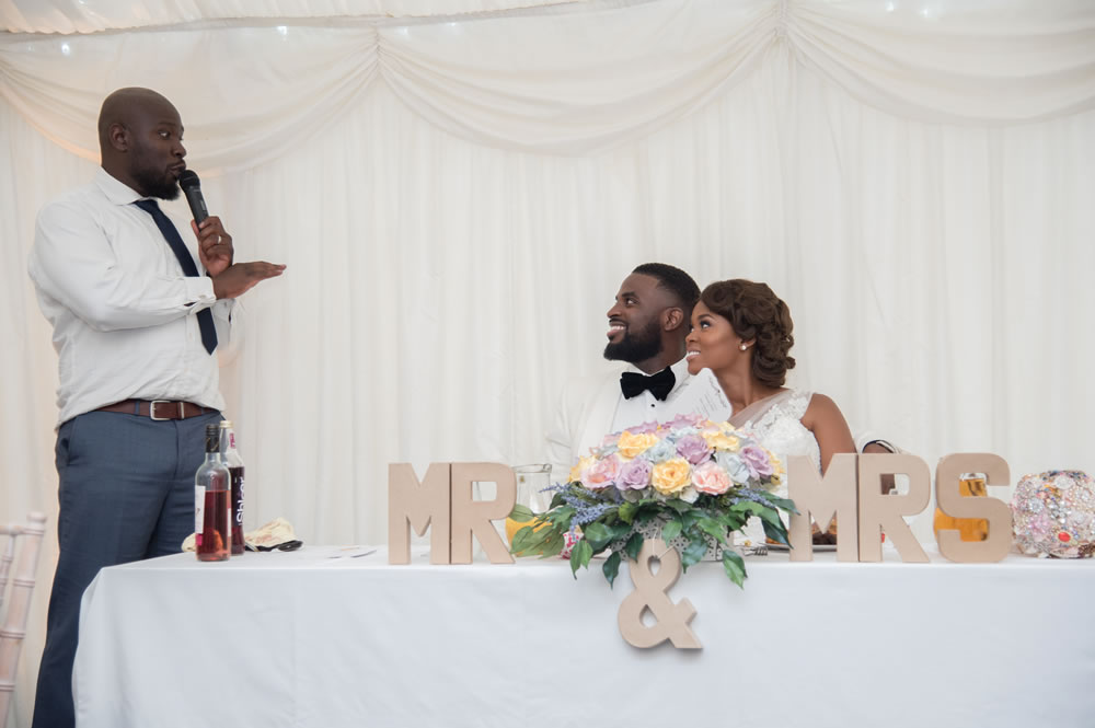 MC talking to couple at the top table