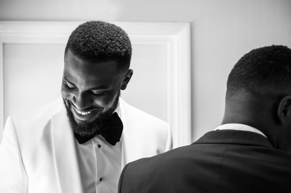 Groom smiling while getting ready