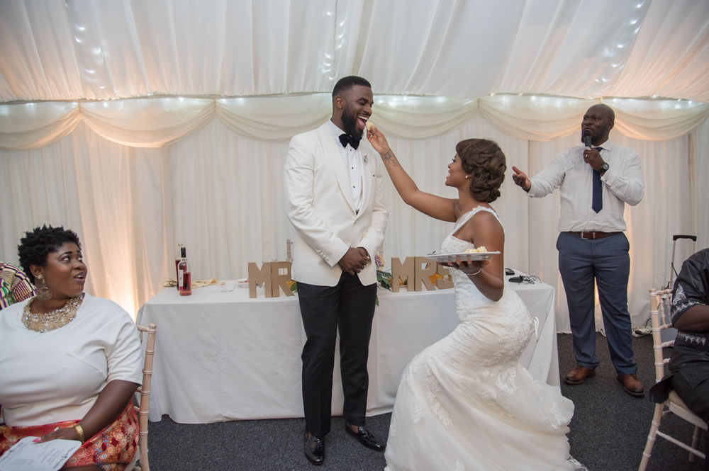 Bride feeding the groom cake