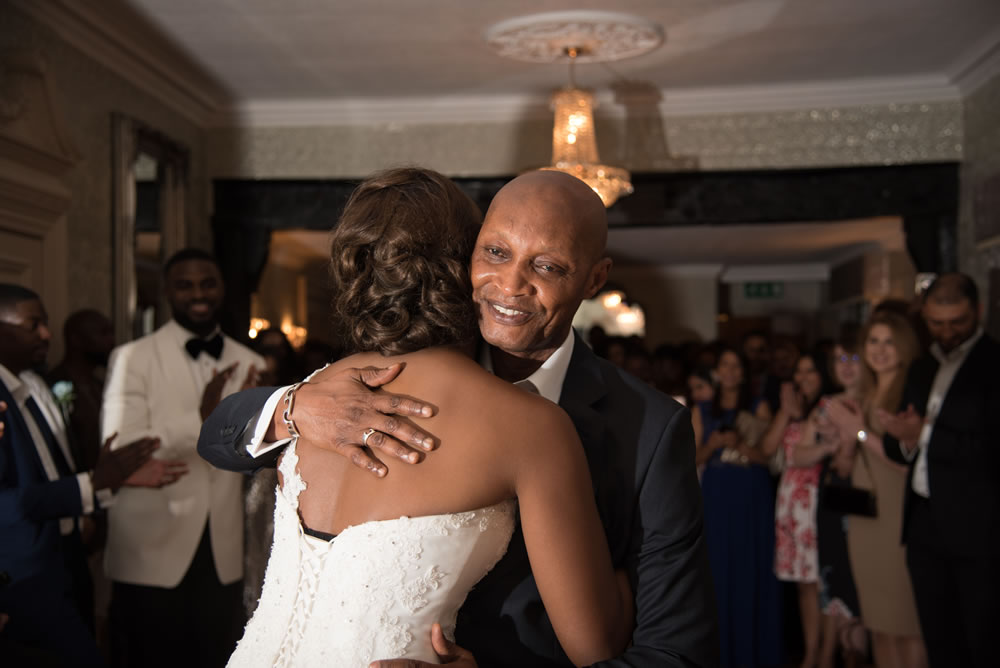 Bride and father hugging