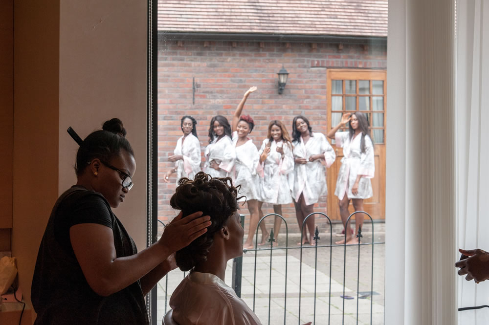 Bride smiling at bridesmaids while getting ready