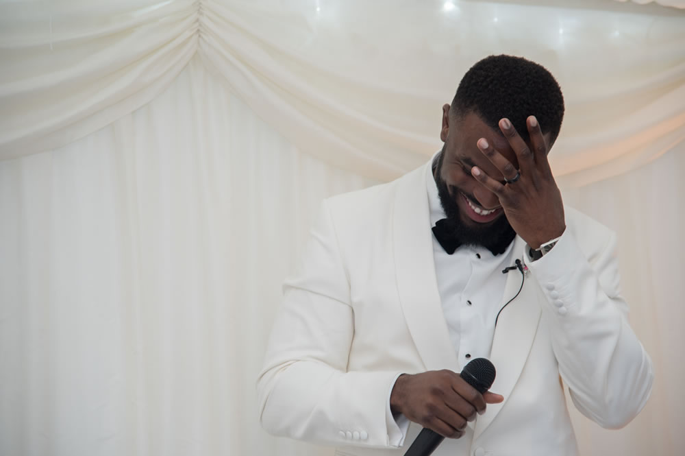 Groom wiping eyes during speech