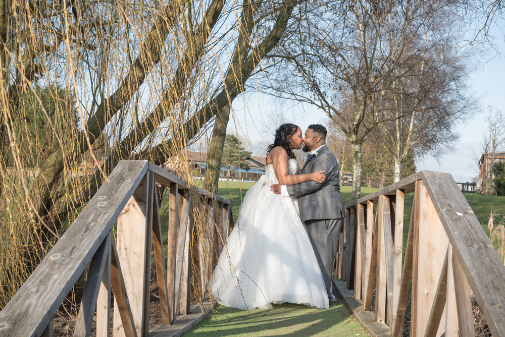 Bride and groom walking on bridge