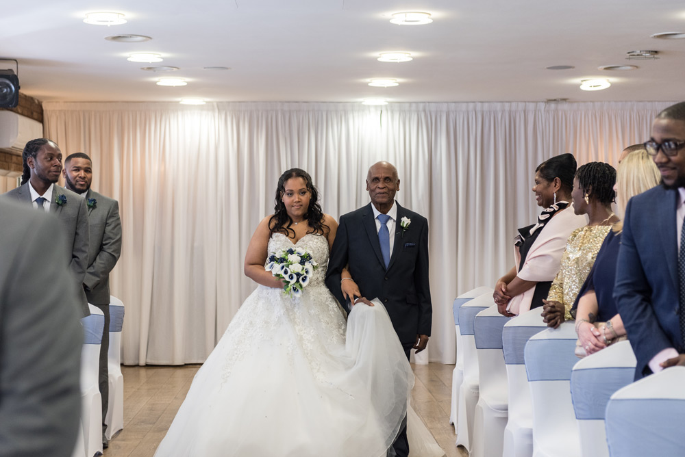 Bride walking in with grandad