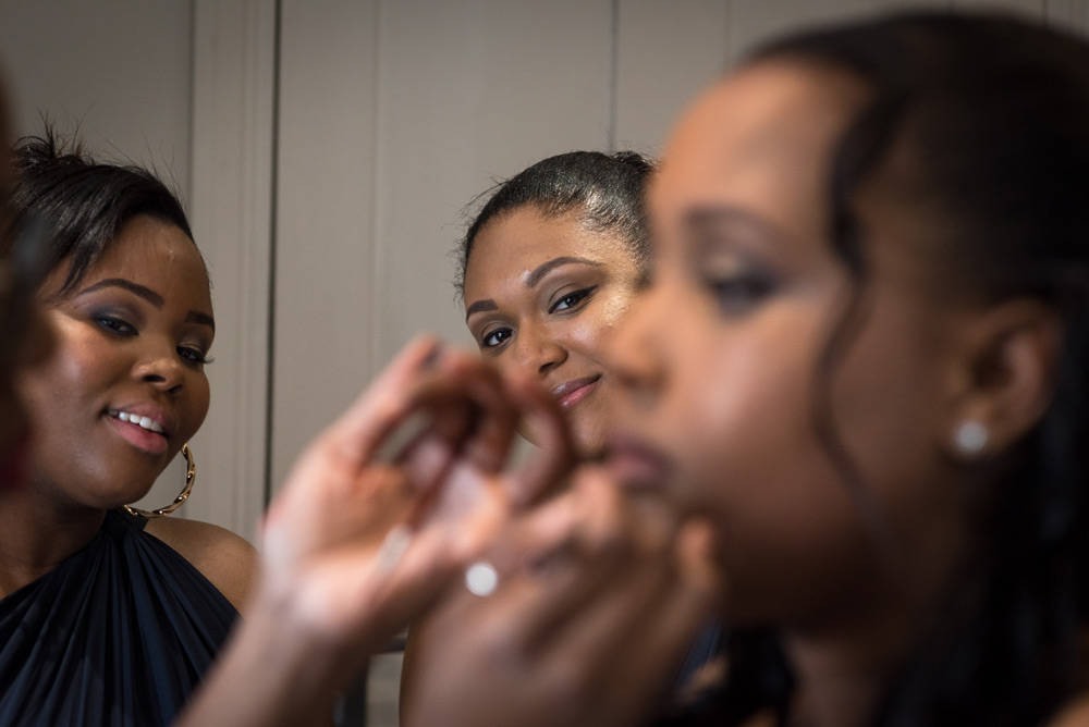 Bridesmaids watching make up being applied