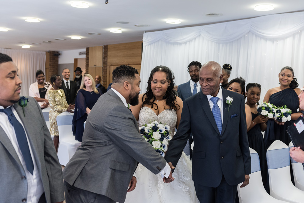 Groom shaking grandad&rsquo;s hand