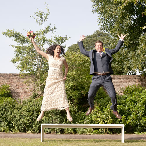 Bride and groom jumping